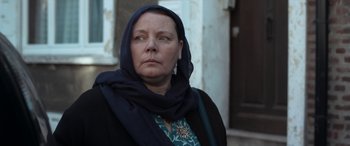 Movie still from “After Love” (2020), directed by Aleem Khan – A woman wearing a head scarf and a black jacket; Close Up shot, Low angle