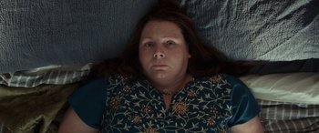 Movie still from “After Love” (2020), directed by Aleem Khan – A person laying on a bed; Close Up shot, Overhead angle