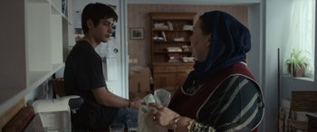 Movie still from “After Love” (2020), directed by Aleem Khan – A man and a woman in a room; Medium shot, Over the shoulder angle