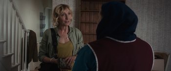 Movie still from “After Love” (2020), directed by Aleem Khan – A woman holding a cell phone in her hand while talking to another woman; Close Up shot, Over the shoulder angle
