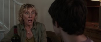 Movie still from “After Love” (2020), directed by Aleem Khan – A woman and a boy sitting in front of each other in a room; Close Up shot, Over the shoulder angle