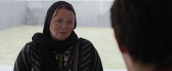Movie still from “After Love” (2020), directed by Aleem Khan – A woman wearing a black headscarf looking into a mirror; Close Up shot, Over the shoulder angle