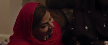 Movie still from “After Love” (2020), directed by Aleem Khan – A person wearing a red head scarf; Close Up shot, Over the shoulder angle