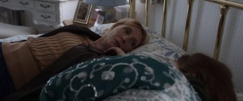 Movie still from “After Love” (2020), directed by Aleem Khan – A woman laying in a bed looking up at the camera; Medium shot, High angle