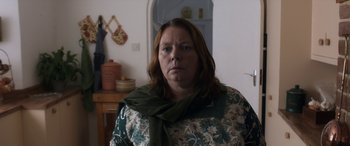Movie still from “After Love” (2020), directed by Aleem Khan – A woman with long hair wearing a green scarf; Close Up shot, Over the shoulder angle