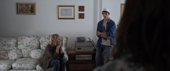 Movie still from “After Love” (2020), directed by Aleem Khan – A man and a woman standing next to each other in a room; Medium shot, Over the shoulder angle