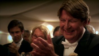 Movie still from “After the Wedding” (2006), directed by Susanne Bier – A man in a tuxedo clapping at a party; Close Up shot, Over the shoulder angle