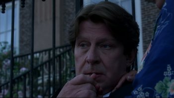Movie still from “After the Wedding” (2006), directed by Susanne Bier – A person with his hand on his chin; Close Up shot, Over the shoulder angle