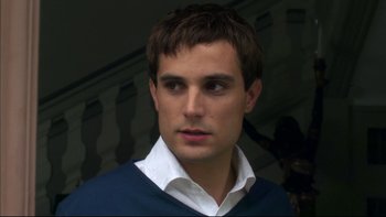 Movie still from “After the Wedding” (2006), directed by Susanne Bier – A person wearing a shirt and a sweater; Close Up shot, Over the shoulder angle