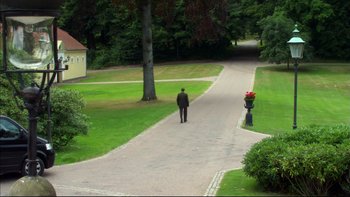 Movie still from “After the Wedding” (2006), directed by Susanne Bier – A man walking down a road in a park; Extreme Wide shot, High angle