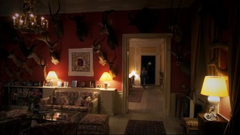 Movie still from “After the Wedding” (2006), directed by Susanne Bier – A living room filled with couches and a fire place; Wide shot, High angle