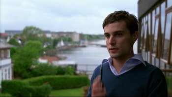 Movie still from “After the Wedding” (2006), directed by Susanne Bier – A man standing in front of a body of water; Close Up shot, Over the shoulder angle