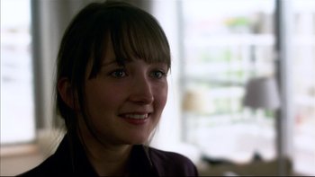 Movie still from “After the Wedding” (2006), directed by Susanne Bier – A person smiling for the camera; Close Up shot, Over the shoulder angle
