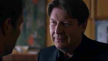 Movie still from “After the Wedding” (2006), directed by Susanne Bier – A person wearing a black shirt; Close Up shot, Over the shoulder angle