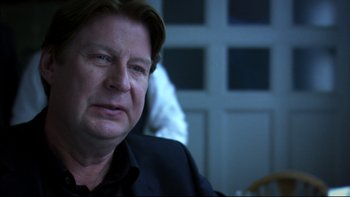 Movie still from “After the Wedding” (2006), directed by Susanne Bier – A person sitting in a chair; Close Up shot, Over the shoulder angle