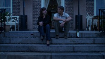 Movie still from “After the Wedding” (2006), directed by Susanne Bier – A man and a woman sitting on the steps of a house; Medium shot, Low angle