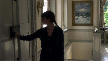 Movie still from “After the Wedding” (2006), directed by Susanne Bier – A woman standing in front of an open door; Medium shot, Low angle