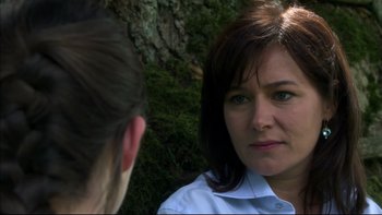 Movie still from “After the Wedding” (2006), directed by Susanne Bier – A woman in white shirt talking to another person; Close Up shot, Over the shoulder angle