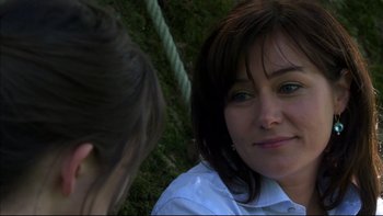 Movie still from “After the Wedding” (2006), directed by Susanne Bier – A woman sitting next to another woman on a swing; Close Up shot, Over the shoulder angle