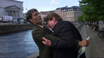 Movie still from “After the Wedding” (2006), directed by Susanne Bier – A couple of people that are hugging each other; Medium shot, Low angle