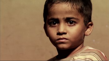 Movie still from “After the Wedding” (2006), directed by Susanne Bier – A young boy's face looking at the camera; Extreme Close Up shot, High angle