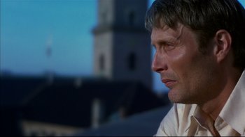 Movie still from “After the Wedding” (2006), directed by Susanne Bier – A man's face in front of a building; Close Up shot, Low angle
