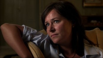 Movie still from “After the Wedding” (2006), directed by Susanne Bier – A person sitting on a couch; Close Up shot, Over the shoulder angle