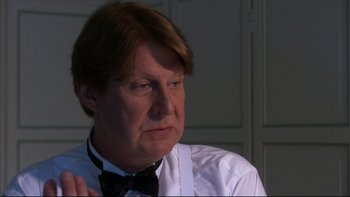 Movie still from “After the Wedding” (2006), directed by Susanne Bier – A person wearing a shirt and a bow tie; Close Up shot, Over the shoulder angle
