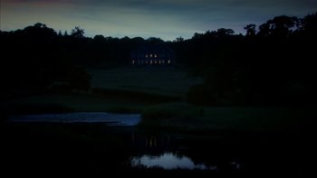 Movie still from “After the Wedding” (2006), directed by Susanne Bier – A house in the distance is lit up at night; Extreme Wide shot, Low angle