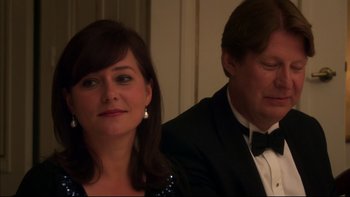 Movie still from “After the Wedding” (2006), directed by Susanne Bier – A man and a woman sitting next to each other in formal wear; Close Up shot, Over the shoulder angle