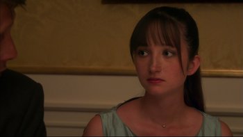 Movie still from “After the Wedding” (2006), directed by Susanne Bier – A young woman looking to her left while sitting in a room; Close Up shot, Over the shoulder angle