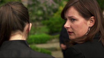 Movie still from “After the Wedding” (2006), directed by Susanne Bier – A woman in a black jacket talking to another woman; Close Up shot, Over the shoulder angle