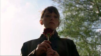 Movie still from “After the Wedding” (2006), directed by Susanne Bier – A woman holding a red rose in front of her face; Close Up shot, Low angle