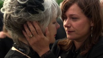 Movie still from “After the Wedding” (2006), directed by Susanne Bier – Two women standing next to each other and one of them has her hand on the ear of another woman; Close Up shot, Over the shoulder angle