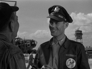 Movie still from “Air Force” (1943), directed by Howard Hawks – A man wearing a hat and a jacket; Medium shot, Over the shoulder angle