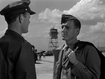 Movie still from “Air Force” (1943), directed by Howard Hawks – A man in a military uniform talking to another man in an army uniform; Medium shot, Low angle