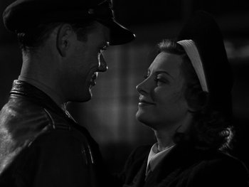 Movie still from “Air Force” (1943), directed by Howard Hawks – A man and a woman looking at one another; Close Up shot, Low angle