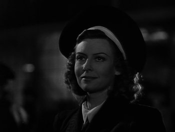 Movie still from “Air Force” (1943), directed by Howard Hawks – A black and white photo of a woman wearing a hat; Close Up shot, Low angle