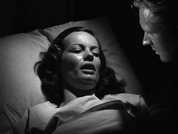 Movie still from “Air Force” (1943), directed by Howard Hawks – A woman laying in a hospital bed next to a man; Close Up shot, Over the shoulder angle