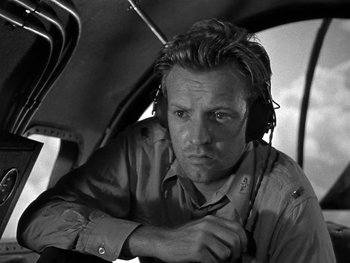 Movie still from “Air Force” (1943), directed by Howard Hawks – Black and white photograph of a man wearing headphones; Close Up shot, Low angle