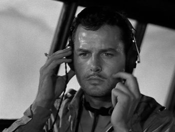 Movie still from “Air Force” (1943), directed by Howard Hawks – Black and white photograph of a man wearing headphones; Close Up shot, Low angle