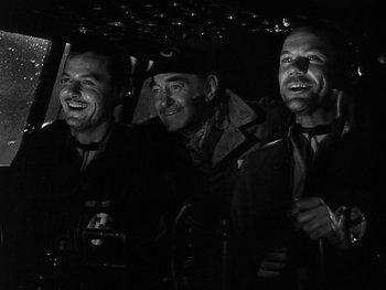 Movie still from “Air Force” (1943), directed by Howard Hawks – A group of men standing next to each other in a car; Medium shot, Low angle
