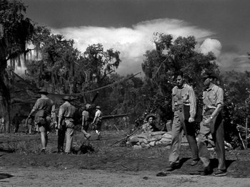 Movie still from “Air Force” (1943), directed by Howard Hawks – A black and white photo of men in uniform; Wide shot, Low angle