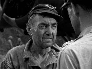 Movie still from “Air Force” (1943), directed by Howard Hawks – An older man wearing a hat and a jacket; Close Up shot, Over the shoulder angle