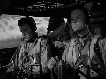 Movie still from “Air Force” (1943), directed by Howard Hawks – A group of men standing next to each other in a helicopter; Medium shot, Low angle