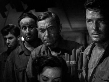 Movie still from “Air Force” (1943), directed by Howard Hawks – A black and white photo of a group of people; Medium shot, Low angle