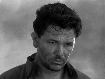 Movie still from “Air Force” (1943), directed by Howard Hawks – Black and white photograph of a man with wet hair; Close Up shot, Low angle