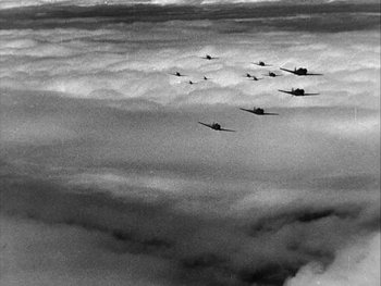 A group of planes flying through the sky