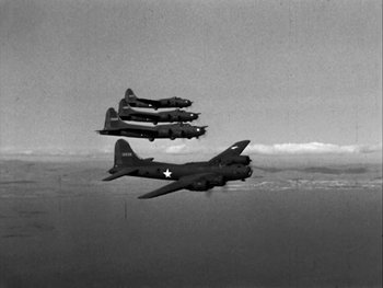 Movie still from “Air Force” (1943), directed by Howard Hawks – A black and white photo of four planes flying in the sky; Wide shot, Low angle
