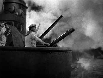 Movie still from “Air Force” (1943), directed by Howard Hawks – An old photo of a man on a boat in the water; Medium shot, High angle